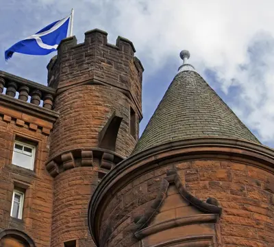 a flag flying on top of a brick building at Sherbrooke Castle Hotel in Glasgow