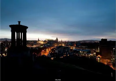 a view of a city at night at JOIVY Boutique Apt with Patio in New Town in Edinburgh
