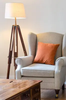 a living room with a chair and a lamp at JOIVY Stylish Apt in Trendy New Town Location in Edinburgh
