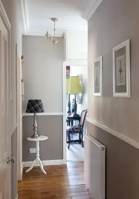 a hallway with a table and a chair in a room at JOIVY Charming Nest for Two with Castle View in Edinburgh