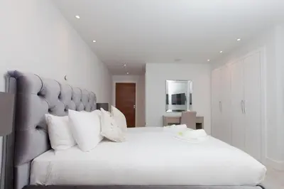 a bedroom with a large bed with white sheets and pillows at Luxurious Central Edinburgh Apartment - Sleeps 6 in Edinburgh