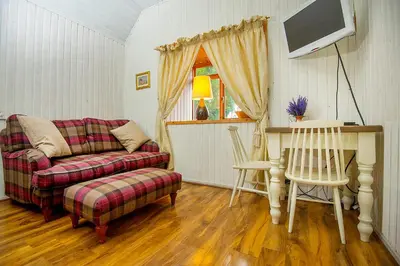 a living room with a couch and a tv at The Falls Of Dochart Inn in Killin