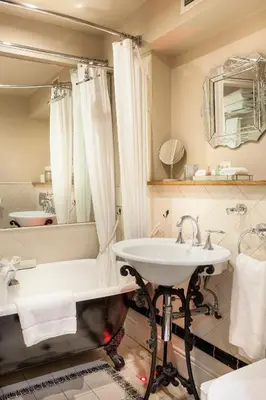 a bathroom with a tub and a sink at Glenskirlie Castle Hotel in Banknock