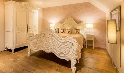 a bedroom with a large white bed in a room at Glenskirlie Castle Hotel in Banknock