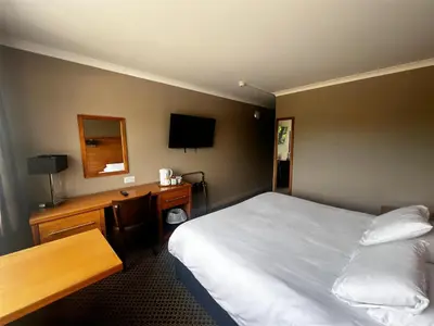 a hotel room with a bed and a desk at Park Hotel in Falkirk