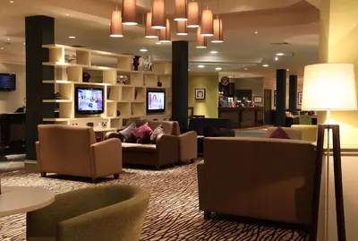 a hotel lobby with couches and chairs and a chandelier at Doubletree By Hilton Glasgow Strathclyde in Bellshill
