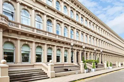 a large building with stairs in front of it at Glasgow Grosvenor Hotel in Glasgow