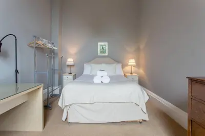 a bedroom with a white bed with two towels on it at JOIVY Spacious Apt in New Town Prime Location in Edinburgh