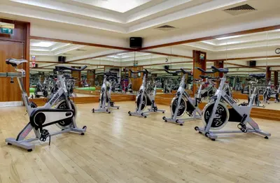 a gym with a row of treadmills and ellipticals at DoubleTree by Hilton Edinburgh Airport in Ingliston