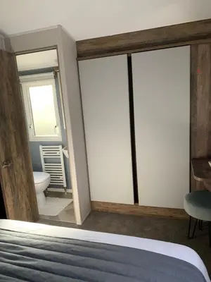 a room with a bed and a bathroom with a toilet at Brookwood Sea View 14 in Dunoon
