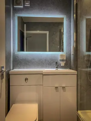 a bathroom with a sink and a mirror at King Robert Hotel in Stirling
