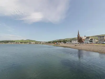 a body of water with a town in the background at MACS Place in Largs