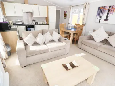 a living room with two couches and a table at 32 Cruachan Lodge in Auchterarder