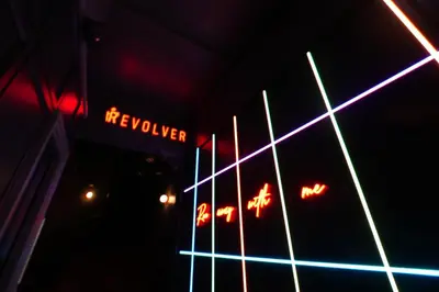 a lit up sign on a building at night at Revolver Edinburgh in Edinburgh