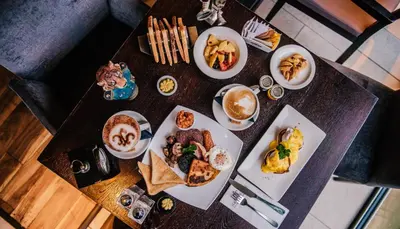 a table with plates of food and coffee on it at The Torrance Hotel in East Kilbride