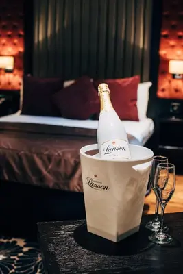 a bottle of champagne in a bucket on a table at The Torrance Hotel in East Kilbride