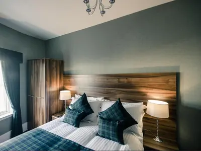 a bedroom with a bed with two pillows at Royal West End Hotel in Glasgow