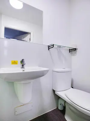 a white bathroom with a sink and a toilet at Lost Guest House Stirling in Stirling