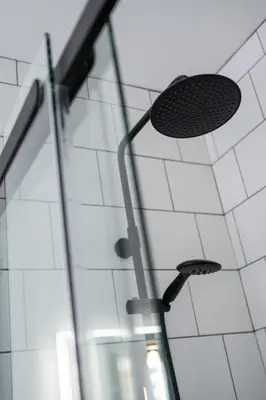 a shower with a glass door and a drain at No. 53 Frederick Street in Edinburgh