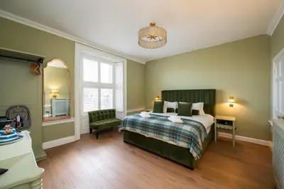a bedroom with a bed and a chair at No. 53 Frederick Street in Edinburgh