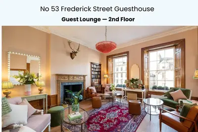 a living room with a couch and a fireplace at No. 53 Frederick Street in Edinburgh