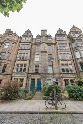 a bike parked in front of a building at 3 bed overlooking meadows park in Edinburgh