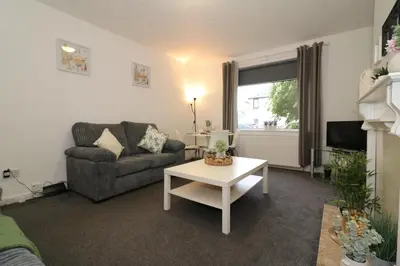 a living room with a couch and a table at Signature - Glen Lee House in Glasgow
