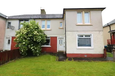 a house with a tree in the front yard at Signature - Glen Lee House in Glasgow
