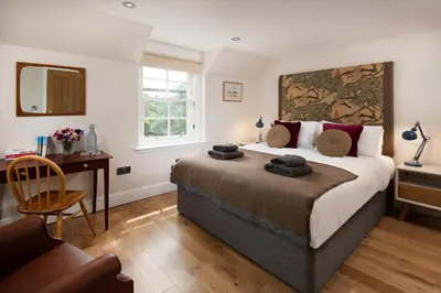 a bedroom with a bed and a desk and a chair at Mill House Monzie in Crieff