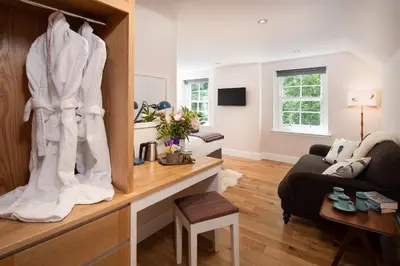 a living room with a couch and a table at Mill House Monzie in Crieff