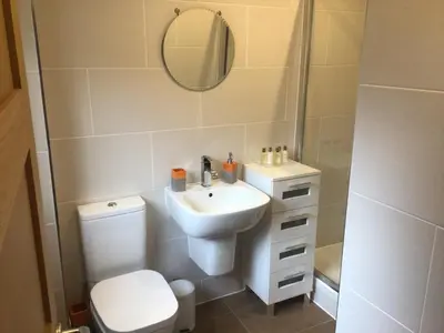a bathroom with a sink and a toilet and a mirror at Burn View in Stronachlachar