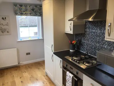 a kitchen with a stove top oven next to a window at Burn View in Stronachlachar