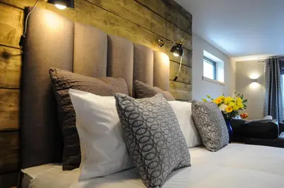 a bedroom with a large bed with pillows at The Corran in Onich