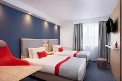 a hotel room with two beds and a tv at Holiday Inn Express Strathclyde Park M74, Jct 5 by IHG in Motherwell