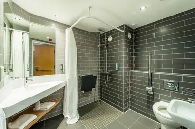 a bathroom with a sink and a shower and a toilet at Holiday Inn Express Strathclyde Park M74, Jct 5 by IHG in Motherwell