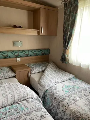 two beds in a small room with a window at Swift bordeaux 24 in Dunoon