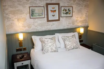 a bedroom with a white bed with two pillows at Ardencaple Hotel by Greene King Inns in Helensburgh