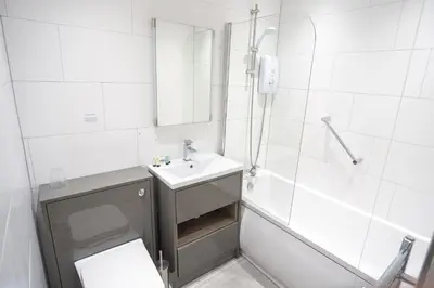 a bathroom with a sink and a shower and a toilet at The Crags Hotel in Callander