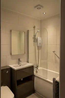 a bathroom with a shower and a sink and a tub at The Crags Hotel in Callander