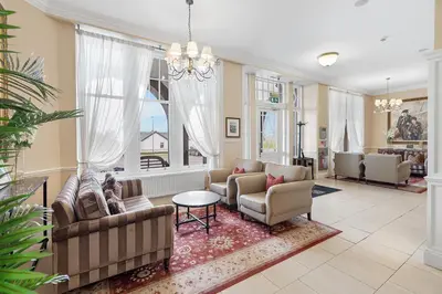 a living room with a couch and chairs and a table at The Ugadale Hotel in Campbeltown