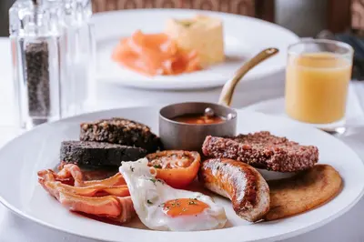 a plate of breakfast food with eggs sausage and toast at The Ugadale Hotel in Campbeltown