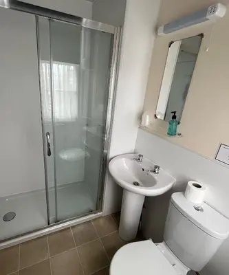 a bathroom with a shower and a toilet and a sink at The Kelvin Hotel in Oban