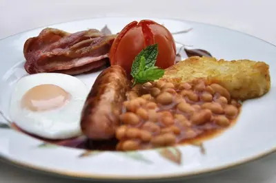 a plate of breakfast food with eggs beans and bacon at Ashgrove House in Edinburgh