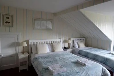 a bedroom with two beds with towels on them at Ashgrove House in Edinburgh