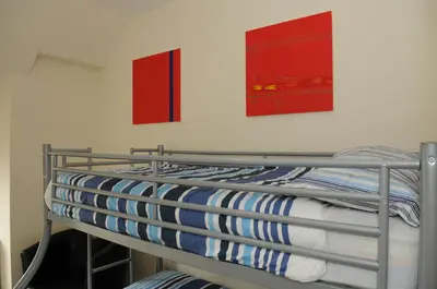a bunk bed in a room with two pictures on the wall at The Hostel in Edinburgh