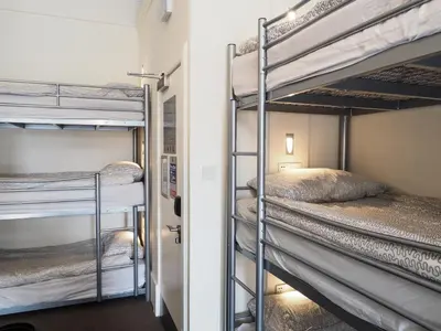 a room with three bunk beds in a room at The Hostel in Edinburgh