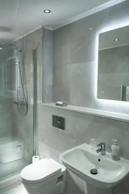 a bathroom with a sink and a toilet and a mirror at Corran House Guest House in Oban