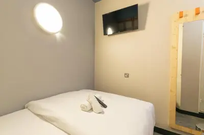 a room with a bed with a towel on it at easyHotel Glasgow City in Glasgow