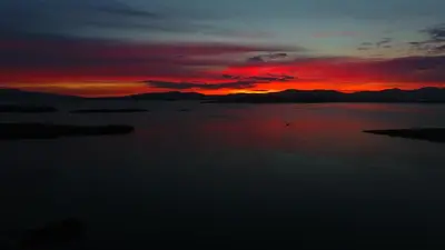 a sunset over a large body of water at Tyndrum Lodges in Tyndrum