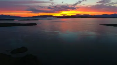 a sunset over a large body of water at Tyndrum Lodges in Tyndrum